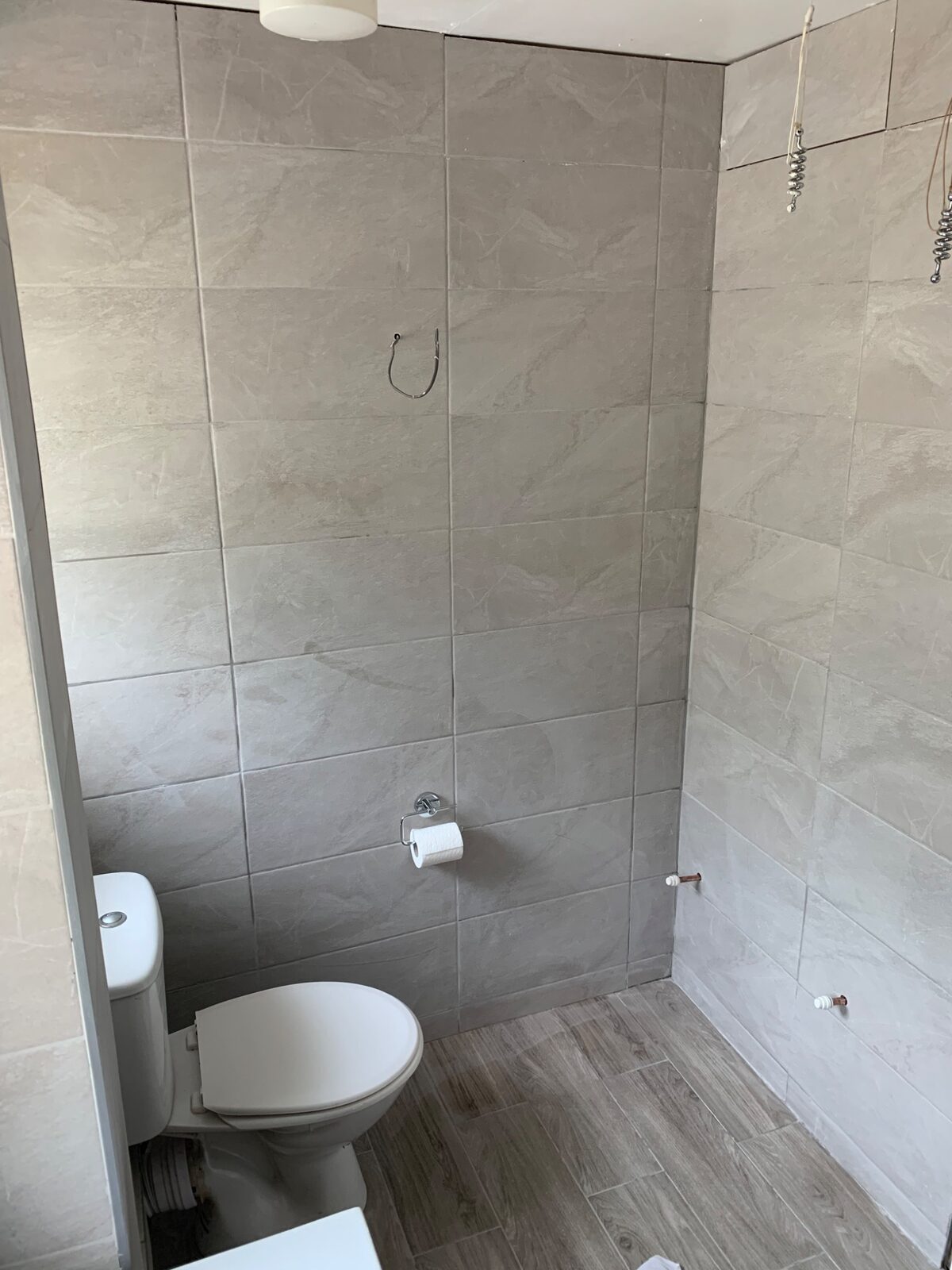 Finished bathroom with black heated towel rail