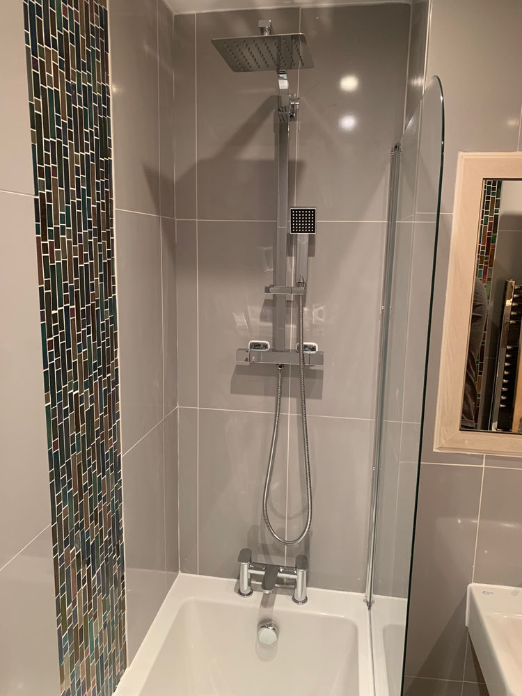 Completed bath shower with tiled surround