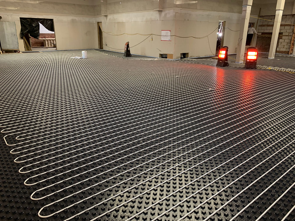 Underfloor heating pipework laid across a large floor